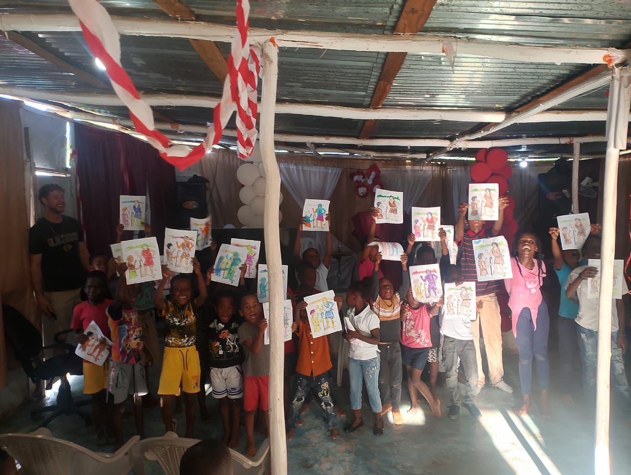 Diverse group of children and volunteers smiling
